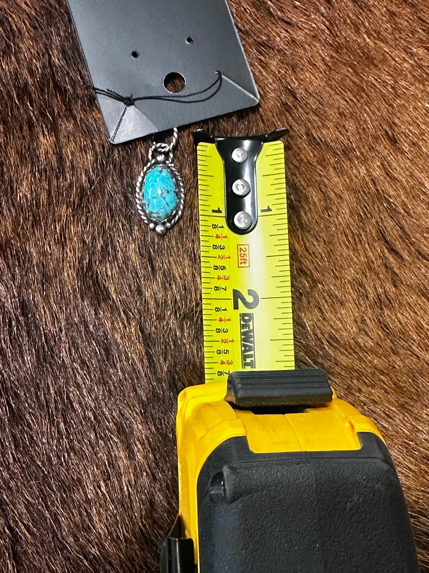Sterling silver pendant featuring a genuine, highly matrixed turquoise stone.