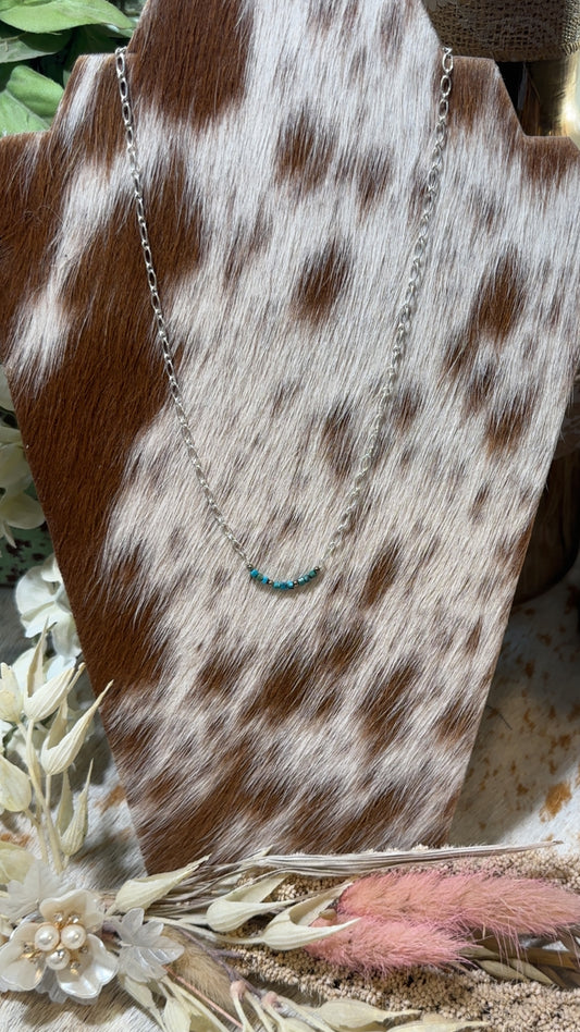 Dainty Sterling chain necklace with a turquoise bead bar pendant. It incorporates genuine turquoise nuggets featuring accents of small silver beads.