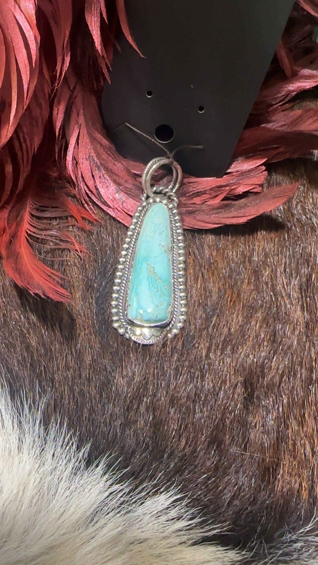 Genuine turquoise and sterling silver Southwest-style pendant