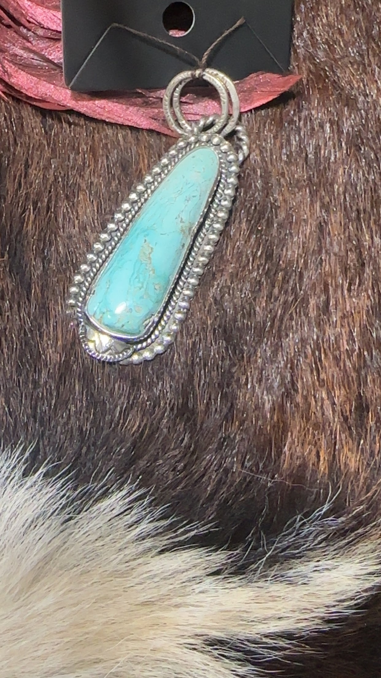 Genuine turquoise and sterling silver Southwest-style pendant